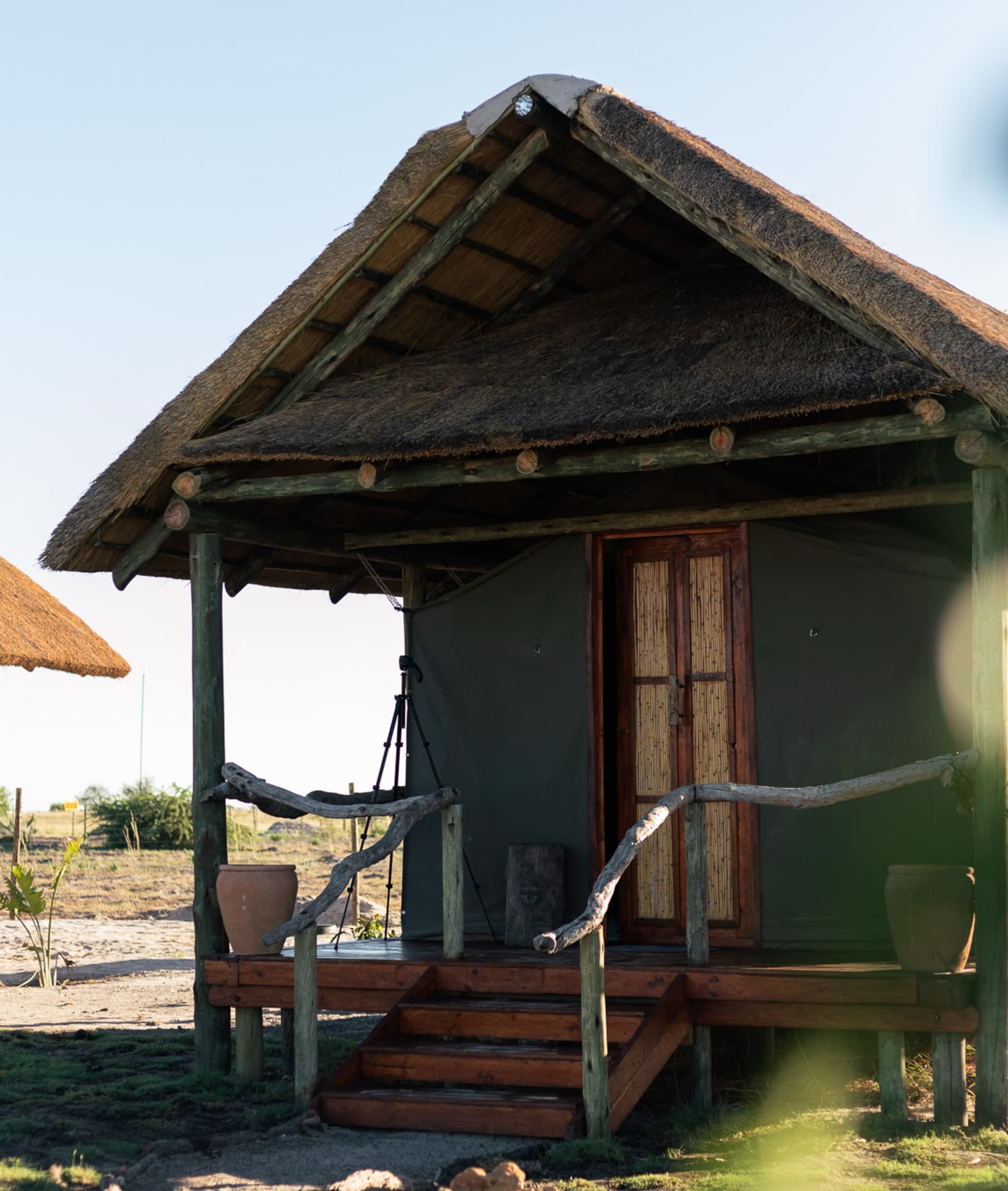 A tented room on wooden decking