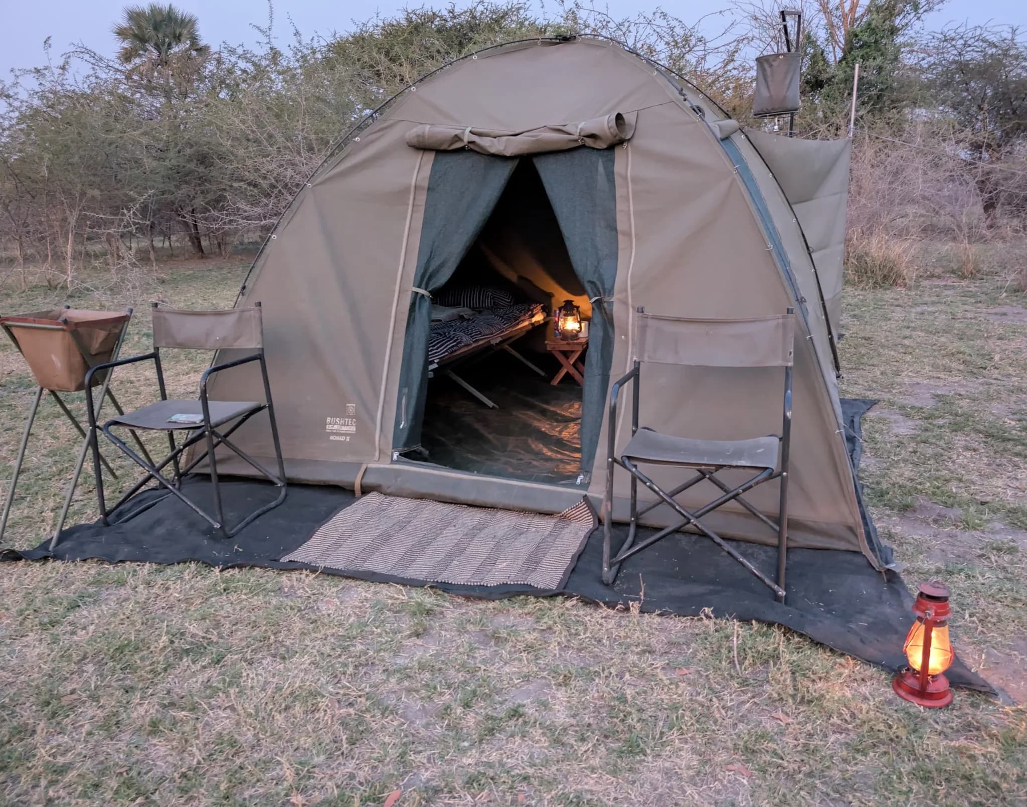 Une tente du camp mobile, avec lavabo et douche à seau